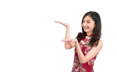 Asian woman wearing chinese dress,cheongsam,qipao present and show something on copy space white isolated background and smileの写真素材