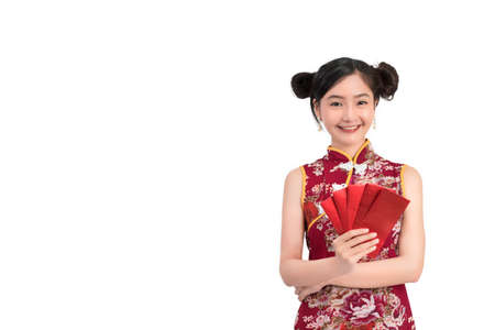 Asian woman wearing chinese dress hold Red envelopes or cheongsam,qipao smile in chinese new year on white isolated background and copy spaceの写真素材