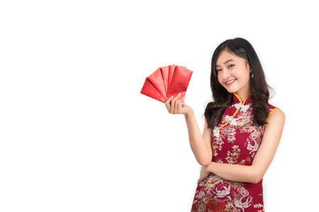 Asian woman wearing chinese dress hold Red envelopes or cheongsam,qipao smile in chinese new year on white isolated backgroundの写真素材