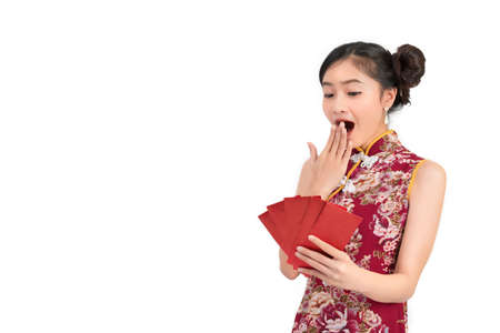 Asian woman wearing chinese dress wow reaction many red envelopes or cheongsam,qipao smile in chinese new year on white isolated backgroundの写真素材