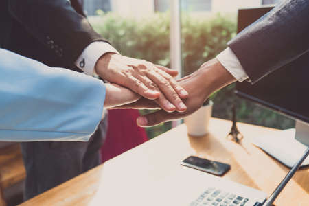 Putting hands of business office partnership colleagues and greeting join in working place collaboration meeting conceptの写真素材