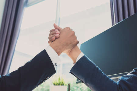 Handshake of business office partnership businessman shaking hands colleagues and greeting join in working place collaboration meeting conceptの写真素材