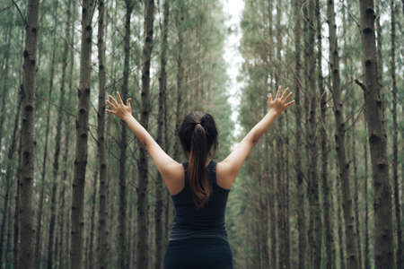 Woman sport resting and relax in the forest after runner workout her having enjoy freedom active healthy lifestyle stretching on summer.の写真素材