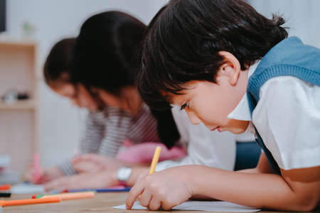 Kindergarten and preschool Kids and teacher drawing,painting on paper learning colorful education.の写真素材
