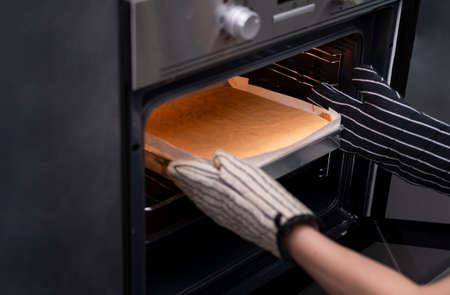 Closeup hands holding homemade bakery bread with microwave oven preparing breakfast food snack...