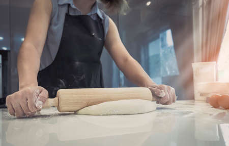 Woman making bakery and preparing bread with rolling dough homemade gingerbread cake add grain on...