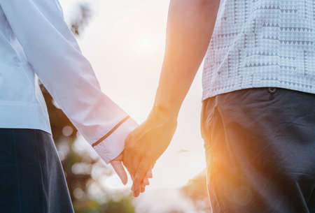 Young couple asian dating in the park walking with holding hands lover together romantic at sunset.の写真素材