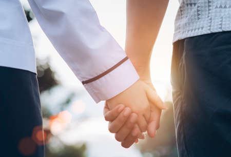 Young couple asian dating in the park walking with holding hands lover together romantic at sunset.の写真素材