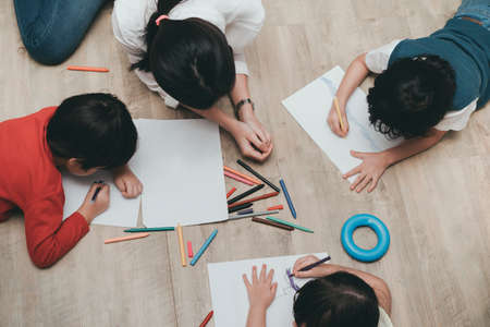 Kindergarten and preschool Kids and teacher drawing,painting on paper learning colorful education top view.の写真素材