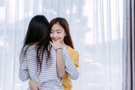 Same sex asian lesbian couple lover embrace in the bedroom at morning happiness feeling, LGBT sexuality female hug living together at home.の写真素材
