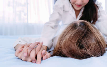 Same sex asian lesbian couple lover erotic scene in the bedroom happiness feeling, LGBT sexuality female on bed living together at home.の写真素材