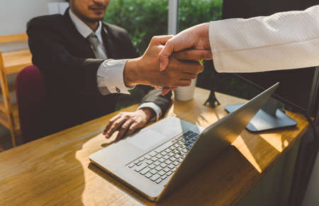 Handshake of business office partnership businessman and businesswoman shaking hands colleagues and...