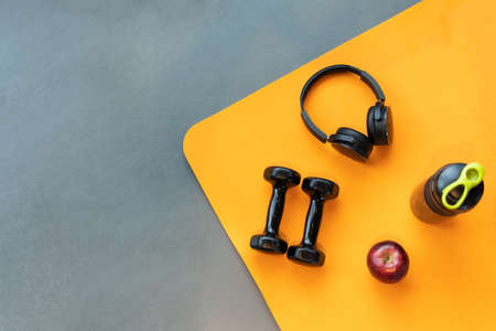 Exercise workout equipment at gym fitness training sport dumbbell,headphone,apple fruit, protein...