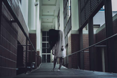 Horror scene of ghost woman death movie halloween festival in the dark house nightmare screaming on hell is monster devil girl or female dead characters at night evil dressing wraith spirit theme.の写真素材