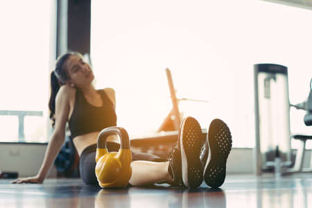 Woman exercise at gym fitness breaking relax after kettlebell workout or sitting tired,rest training sport healthy lifestyle bodybuilding,の写真素材