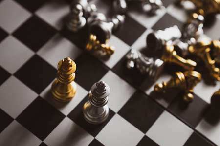 Gold and Silver Chess game king staying on chessboard, Business planing strong conceptの写真素材