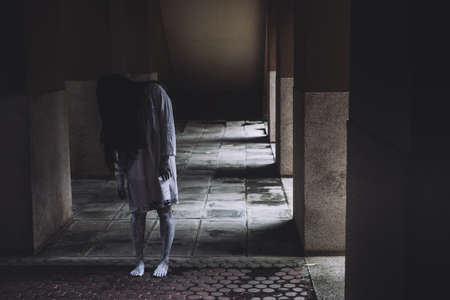 Horror scene of ghost woman death movie film halloween festival in the dark house nightmare screaming on hell is monster devil girl or female dead characters at night evil dressing wraith spirit themeの写真素材