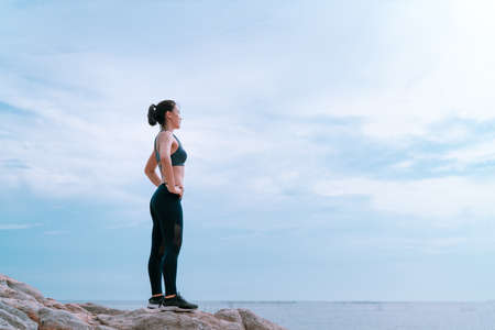 Relaxed and goal challenge athlete asian jogging woman fitness workout outdoor at the beach on sunset for healthy lifestyle after cardio training, Sporty marathon, Success body slim concept copy spaceの写真素材