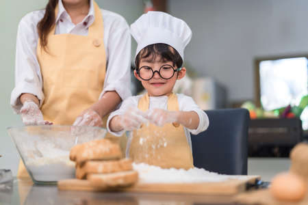 Pastry chef asian little boy making bakery bread cookie and cake delicious sweet food funny moment...