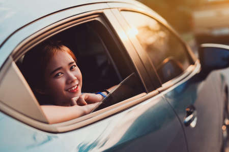 Hatchback Car travel driving road trip of asian woman summer vacation in blue car at sunset, Girls...