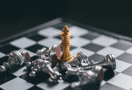 Gold Chess game king staying victory on chessboard, Business planing strong concept with black backgroundの写真素材