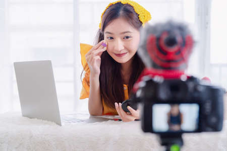 Beauty blogger young Asian woman presentation training makeup skincare video live recording online via digital camera, Vlogger owner small business entrepreneur people lifestyleの写真素材