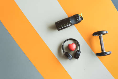 Lover exercise workout equipment at gym fitness training sport dumbbell,headphone,protein shake healthy lifestyle relax bodybuilding on top view copy space the left.の写真素材