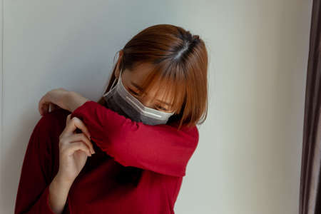 Coronavirus, covid-19 crisis of Sick asian woman patient wearing mask sneeze have fever quarantine...
