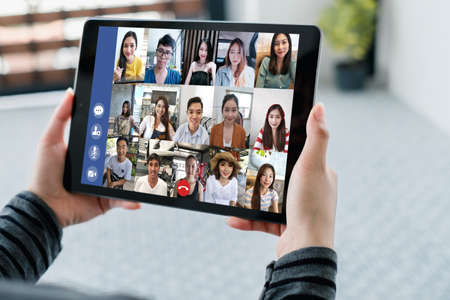 Rear view asian group business people working remotely video conference calling and meeting online...