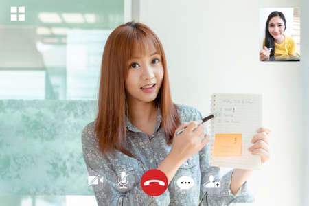 Video conference meeting screen user interface of young asian women, video call presentation list online talking discuss about planning working from home, Quarantine remotely and self isolation.の写真素材