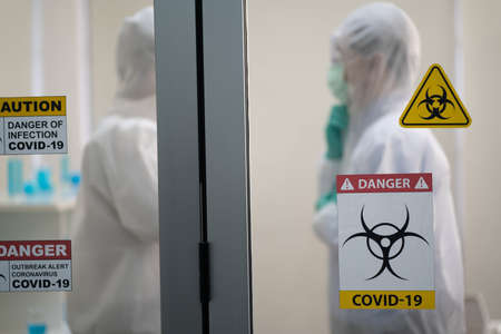 Scientists talking and wearing protection glasses satisfied with great results of completed research,biochemistry.Medical successful concept.の写真素材