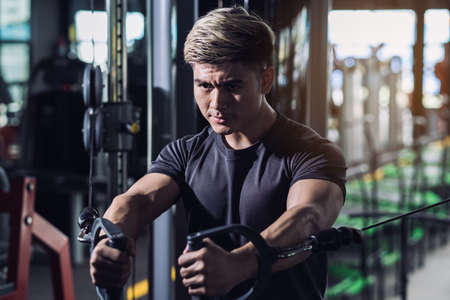 Athlete sportsman workout exercise muscle chest with machine bodybuilding at fitness gym healthy lifestyle endurance heavy weight training, Active fit bodybuilder concept.の写真素材