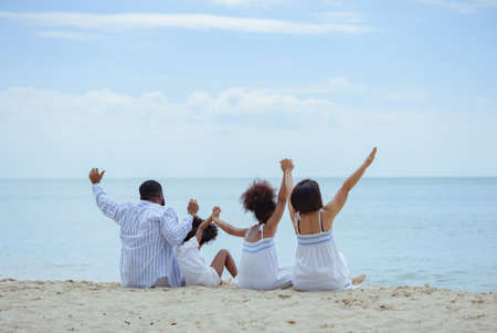 Ethnicity Happy Family Africans Enjoy relaxation resting on the beach summer vacation time happiness group people American, Asian Slow motion footage outdoors nature.の写真素材