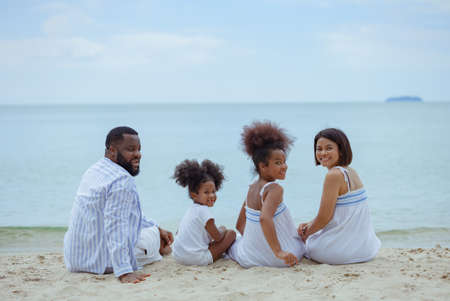 Ethnicity Happy Family Africans Enjoy relaxation resting on the beach summer vacation time happiness group people American, Asian Slow motion footage outdoors nature.の写真素材