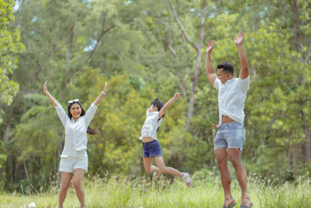 Happy asian family with daughter playing and travel in forest on weekend holidays relaxation adventure together lifestyle.の写真素材
