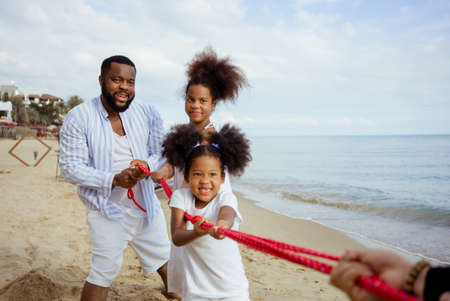 Ethnicity Happy Family Africans Enjoy playing on the beach summer vacation time happiness group people American, Asian outdoors nature.の写真素材