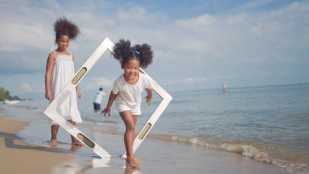 Ethnicity Happy Family Africans Enjoy playing on the beach summer vacation time happiness group people American, Asian outdoors nature.の写真素材
