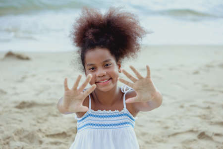 Girl american african playing relax enjoy life funny moment on the beach in sea view nature holiday summer time resting concept.の写真素材