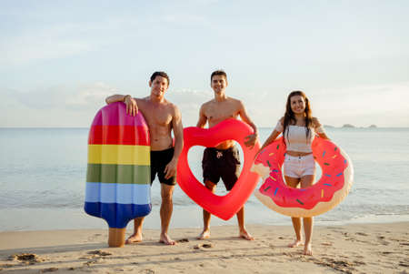 Group friends enjoy life playing and freedom beach at sunset, Attractive together of asian male and female traveler with friends people lifestyle.の写真素材