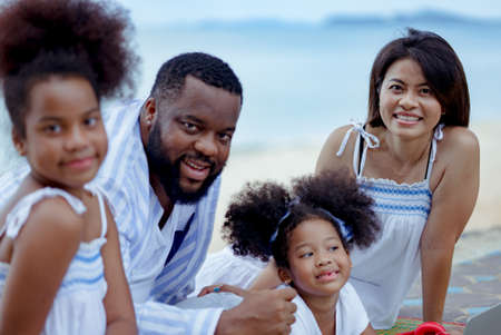 Ethnicity Happy Family Africans Enjoy relaxation resting on the beach summer vacation time happiness group people American, Asian Slow motion footage outdoors nature.の写真素材