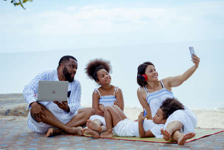 Ethnicity Happy Family Africans Enjoy relaxation resting on the beach summer vacation time happiness group people American, Asian Slow motion footage outdoors nature.の写真素材