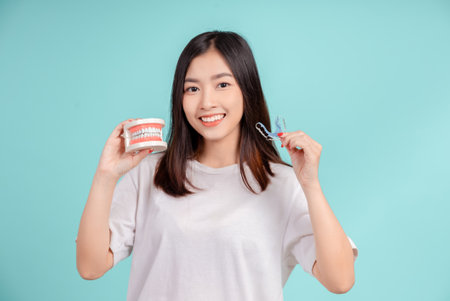 Dental Beautiful smiling of young asian woman with retainer braces glad emotion with white teeth...