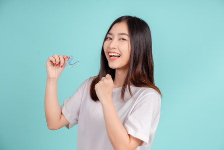Dental Beautiful smiling of young asian woman with retainer braces glad emotion with white teeth...