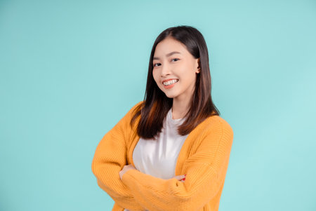 Dental of young asian woman wearing retainer braces glad emotion with white teeth increase confidence for healthy on blue background isolated, Happiness teenager smiling facial expression.の写真素材