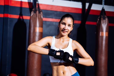Endurance Boxer Asian Woman Ready Fight Boxing Exercise Workout Fit Body Healthy Lifestyle Athlete Muscle Building Strong in Fitneess Gym Health Club.の写真素材