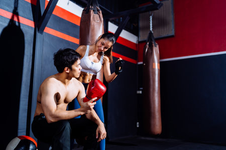 Asian Couple Boxing exercise in Fitness Gym Healthy Lifestyle bodybuilding, Athlete doing punching builder muscles lifestyle, Workout health care mobility concept.の写真素材