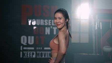 Portrait of Asian Woman Smiling Exercise Workout in Gym Healthy Lifestyle bodybuilding, Athlete builder muscles lifestyle in Fitness club, Happy helth care mobility concept.の写真素材