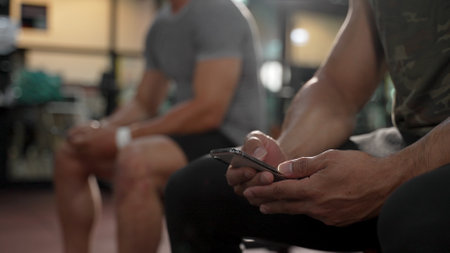 Member in Fitness gym using smartphone technology planing workout, Healthy Lifestyle bodybuilding, Athlete builder muscles lifestyle, Coach training online concept.の写真素材