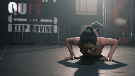 Active Asian Woman Exercise Workout in Gym Healthy Lifestyle bodybuilding doing push up exercise in the fitness gym healthy lifestyle, athlete muscle building strong and fit body.の写真素材