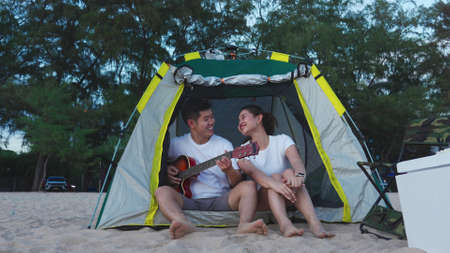 Young Couple in tent on the beach sunset, romantic relationships in vacation holidays, enjoying with travel and resting on summer vacation or holiday concept.の写真素材